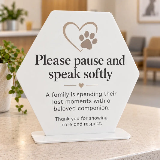 Please pause and speak softly veterinary waiting room sign, white acrylic soft hexagon with taupe heart and paw artwork, with flat 3mm white acrylic base