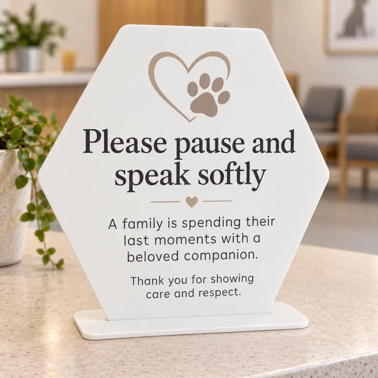 Please pause and speak softly veterinary waiting room sign, white acrylic soft hexagon with taupe heart and paw artwork, with flat 3mm white acrylic base
